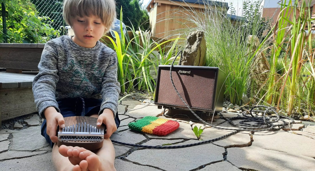 A 7-year-old child learning to play the kalimba
